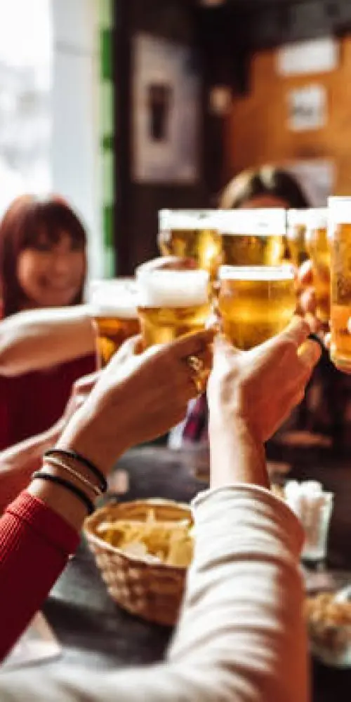 Friends toasting with glasses of craft beer