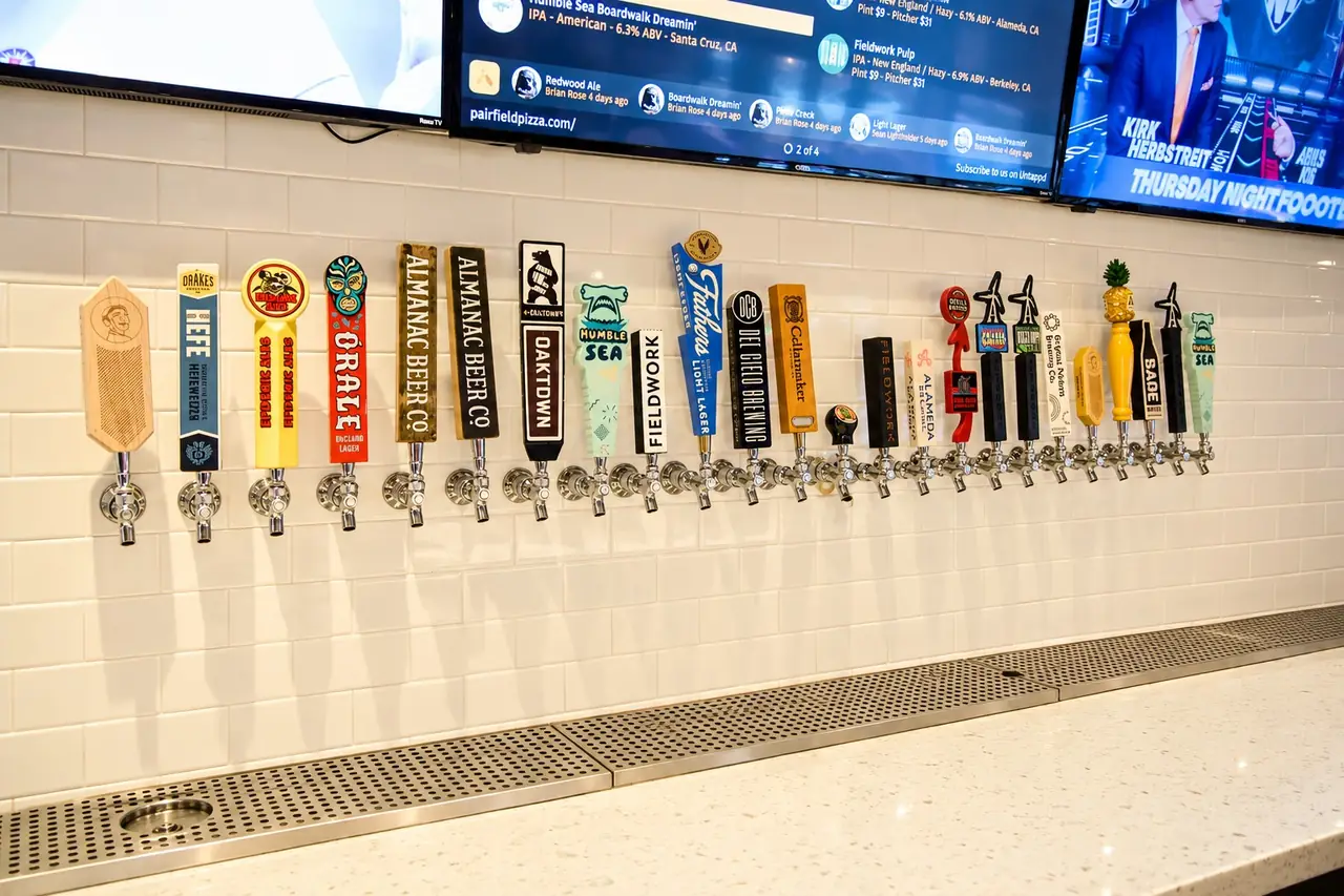 A wall of draft beer tap handles from local breweries at Pairfield Pizza & Pints in San Ramon